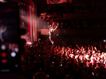 Jean-Noël Scherrer debout sur le public, les bras levés